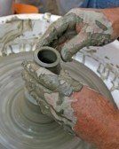 skilled artisan potter during the production of a vessel of clay